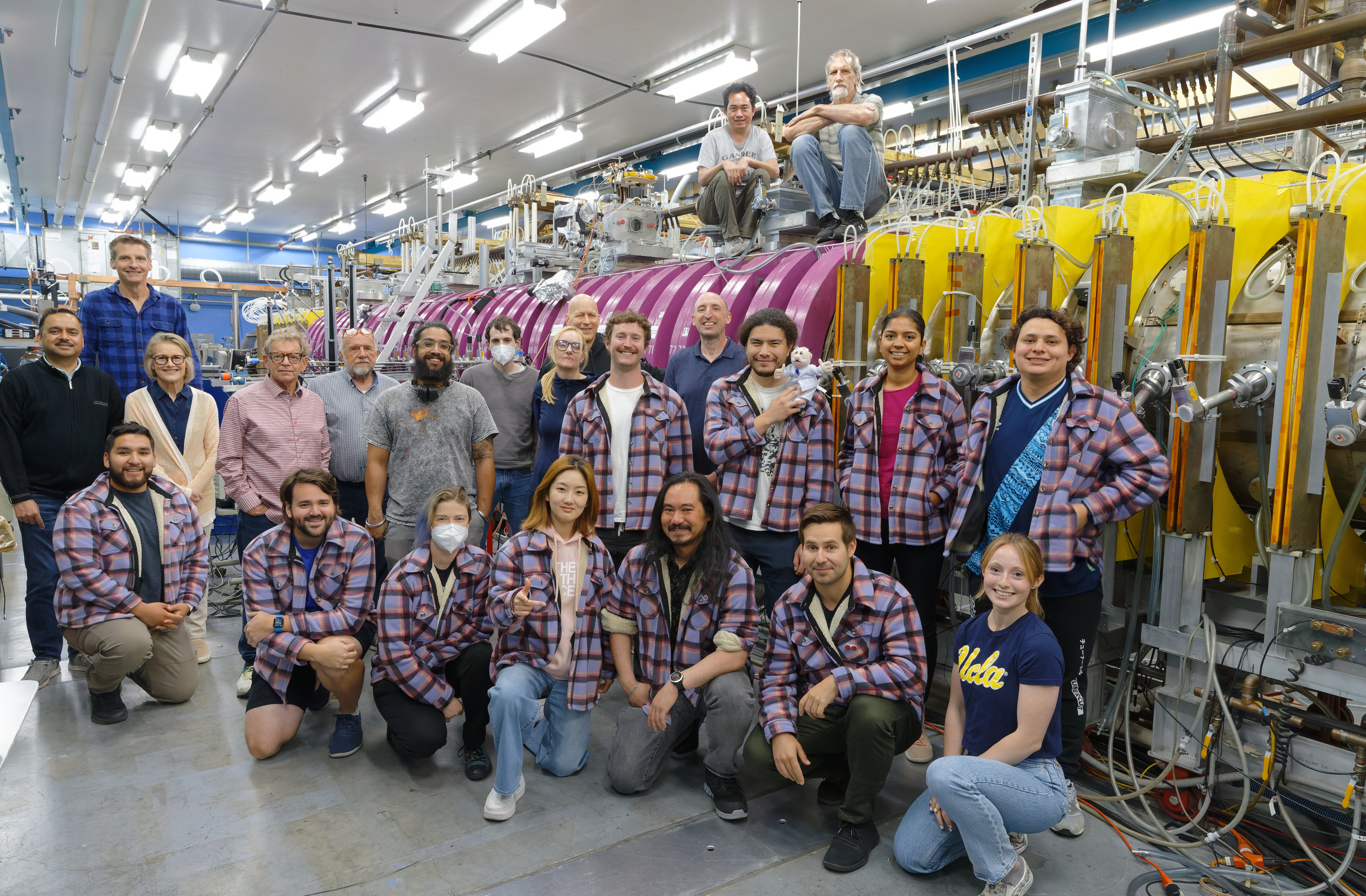 Members of the UCLA Plasma Science and Technology Institute post in front of the university’s large plasma device (PHOTO CREDIT: Phil Travis)