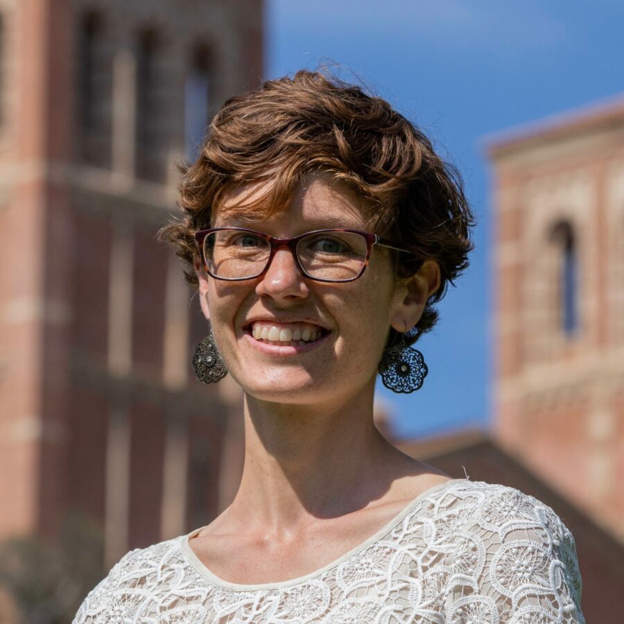 Photo of Karen McKinnon in front of UCLA buildings blurred in the background.